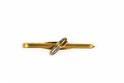 a close up of a gold tie bar on a white background