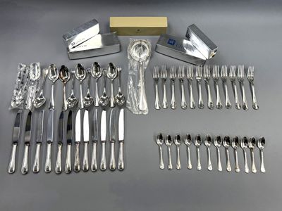 a lot of silverware on a table with a box