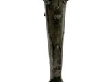 a black vase that is sitting on a white surface