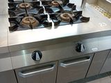 a stainless steel stove top in a commercial kitchen