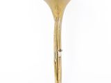 brass trumpet shaped candle holder on a white background