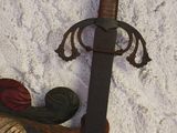 a wooden carving of a sword and a bird on the wall