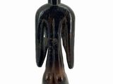 an image of a wooden statue of a man with a hat on his head