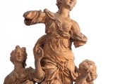 a statue of a woman and three children on a pedestal