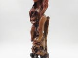 an old wooden statue of a woman holding a baby in her arms
