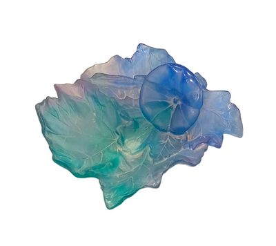 a blue and green glass bowl on a white surface