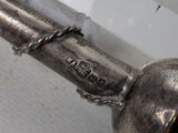 a silver object with a chain around it on top of a table
