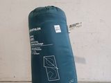 a close up of a blue sleeping bag on a white surface