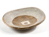 a brown and white bowl on a white surface