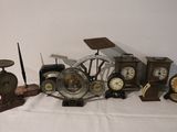a lot of clocks and other items on a table