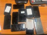 many cell phones that are sitting on a table