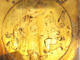 a gold plate with a picture of a man and a woman on it