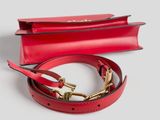 a red leather belt with a gold buckle on a white background
