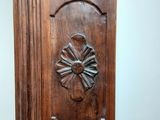 a close up of a wooden door with a clock on it