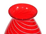 a red glass vase with a spiral design on it
