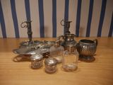 a lot of silver items sitting on a wooden table