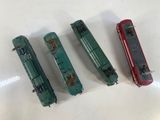 three toy trains sitting next to each other on a table