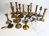 many different types of brass candlesticks on the table