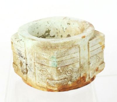 a stone bowl with carvings on it sitting on a table