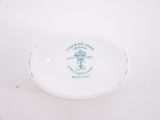 a white plate with a green design on it