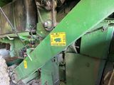 a green machine that is sitting inside of a building