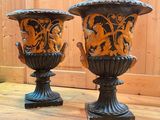 two vases sitting on a wooden floor next to each other
