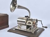 an old fashioned gramphone and a wooden box on a white background