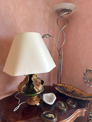a small table with a lamp and a bowl on it