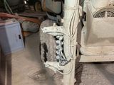 a car that is sitting in a garage with it ' s front wheel missing