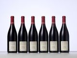 six bottles of red wine lined up in a row