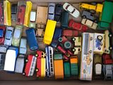 a box full of toy cars and trucks that are in it