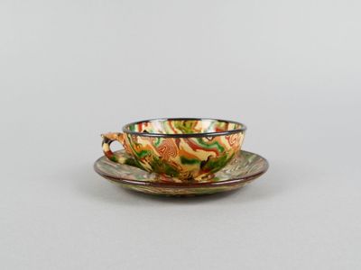 a cup and saucer on a saucer on a table