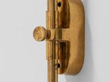 a close up of a brass door handle on a white wall