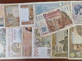 a lot of different foreign currency on the table