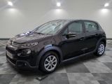 a picture of a small black car parked on a checkered floor