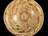 a brown bowl with writing on it on a black background