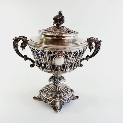 an antique silver plated bowl with a lid on a stand
