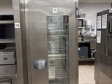 a stainless steel refrigerator in a commercial kitchen with a glass door