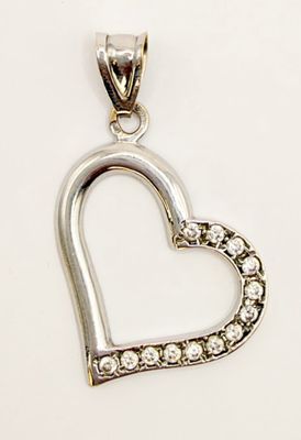 a close up of a diamond heart pendant on a white background