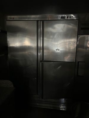 a large stainless steel refrigerator in a dark room