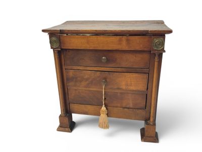 a small wooden table with a tassel on top of it