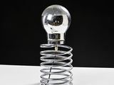 a light bulb that is sitting on top of a spring