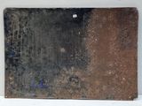 a piece of metal that has been rusted and is on the wall