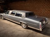 a silver car parked in a garage with a brick wall behind it