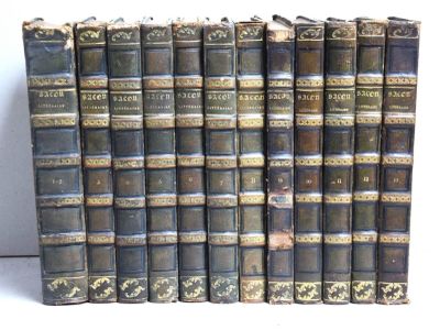 plusieurs vieux livres sont alignés sur une surface blanche