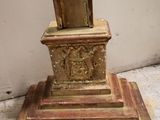 a clock that is sitting on top of a wooden stand