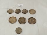 six different types of coins on a table with a price tag