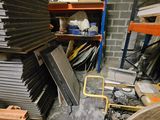 a pile of metal items in a room with shelves