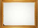a gold framed mirror on a wall with a white background