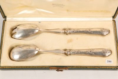 three silver spoons in a box on a table